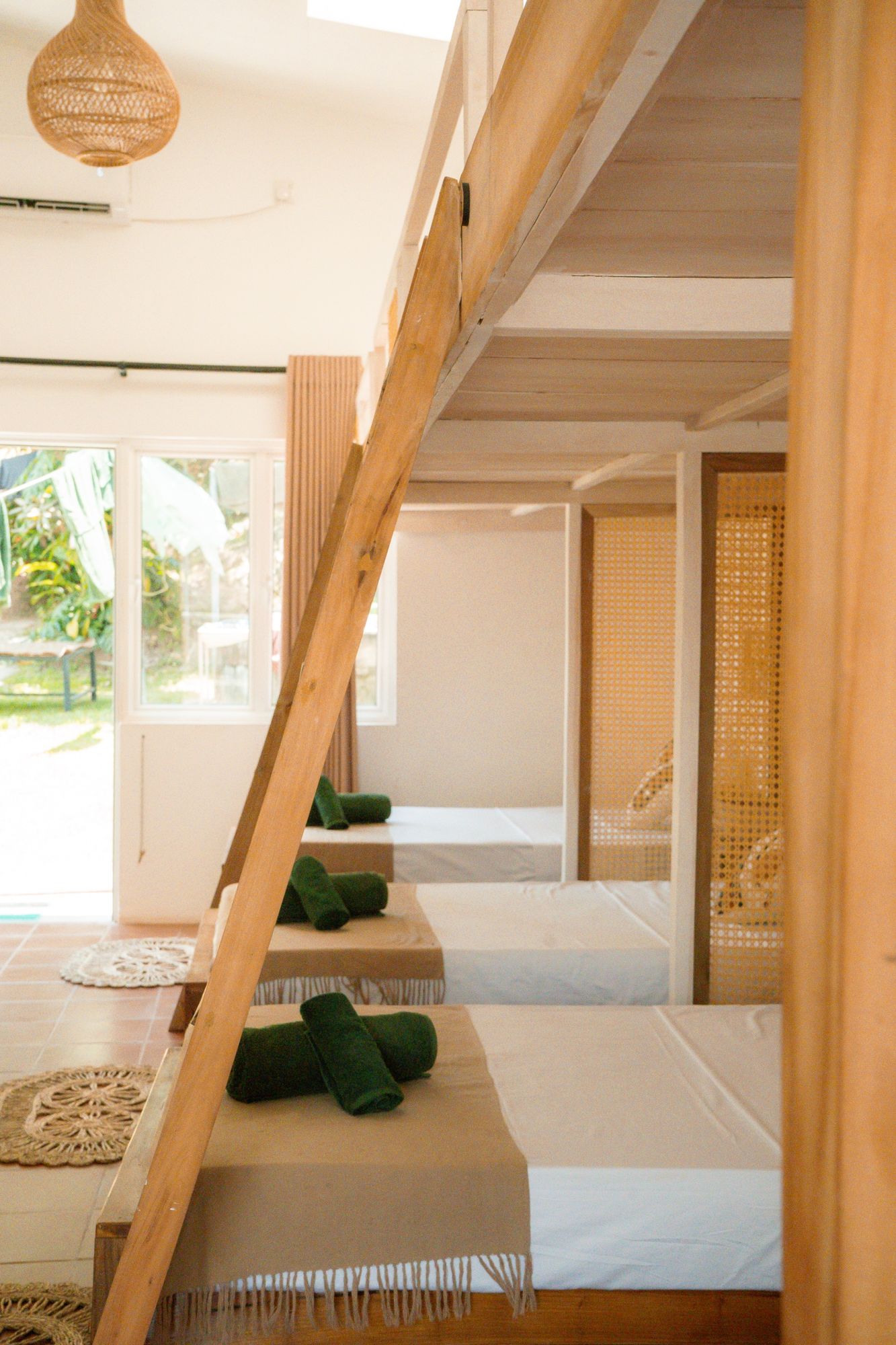 Ladder and made-up beds with green towels