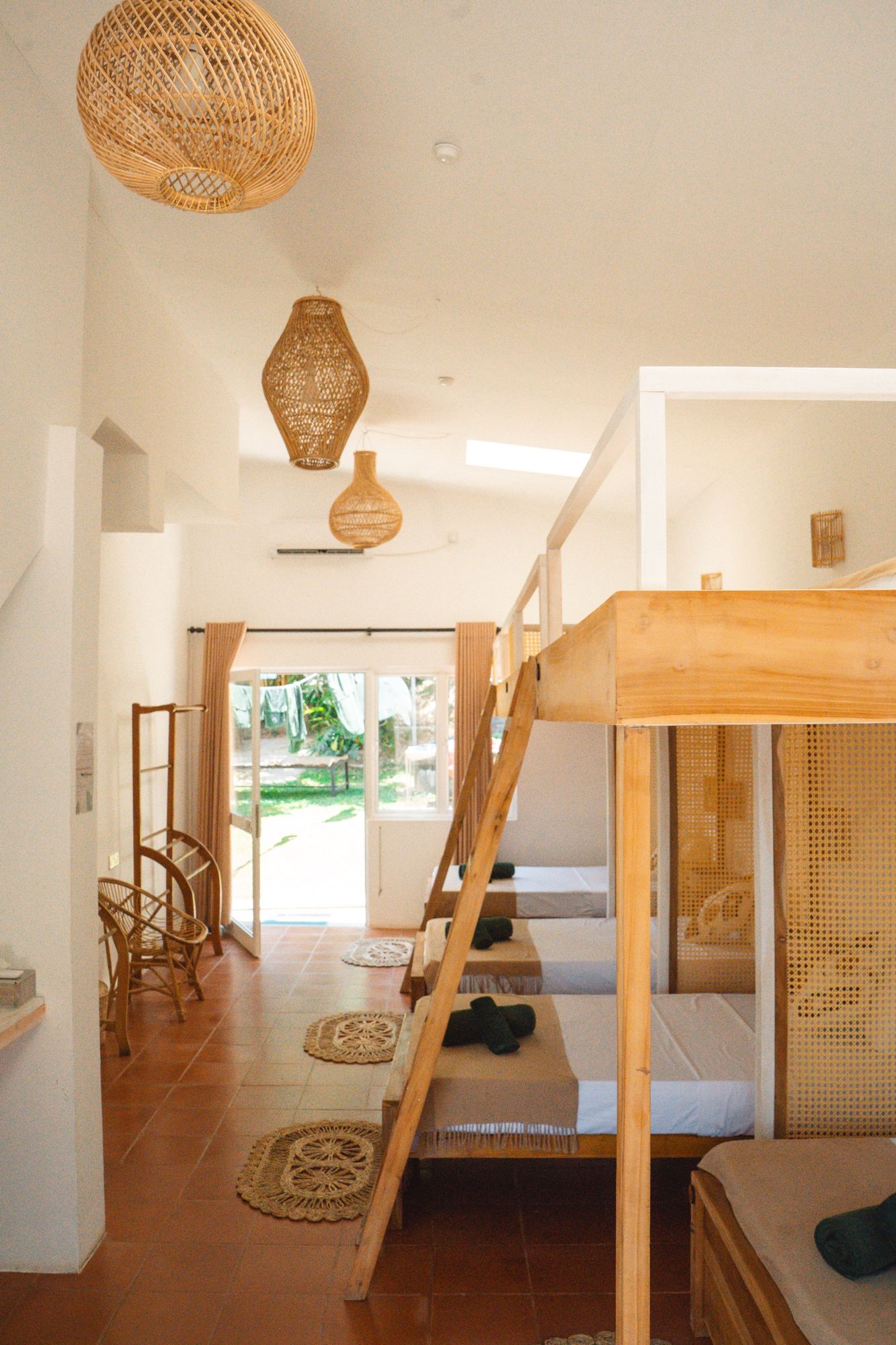 Dorm with rattan pendant lights and garden door