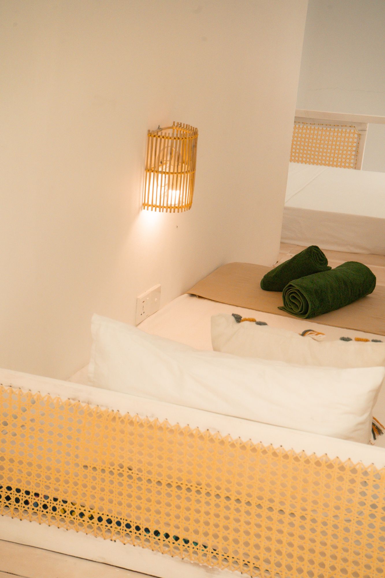 Cane screen, wall light and fresh towels