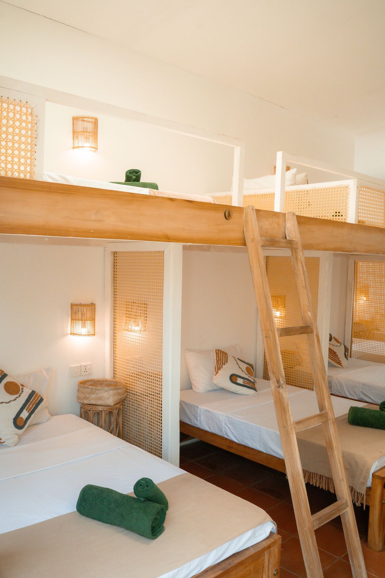 Bunks with warm wall lights and cane screens