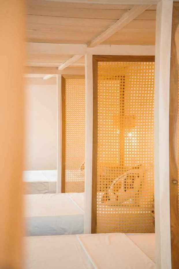 Cane privacy screens between beds