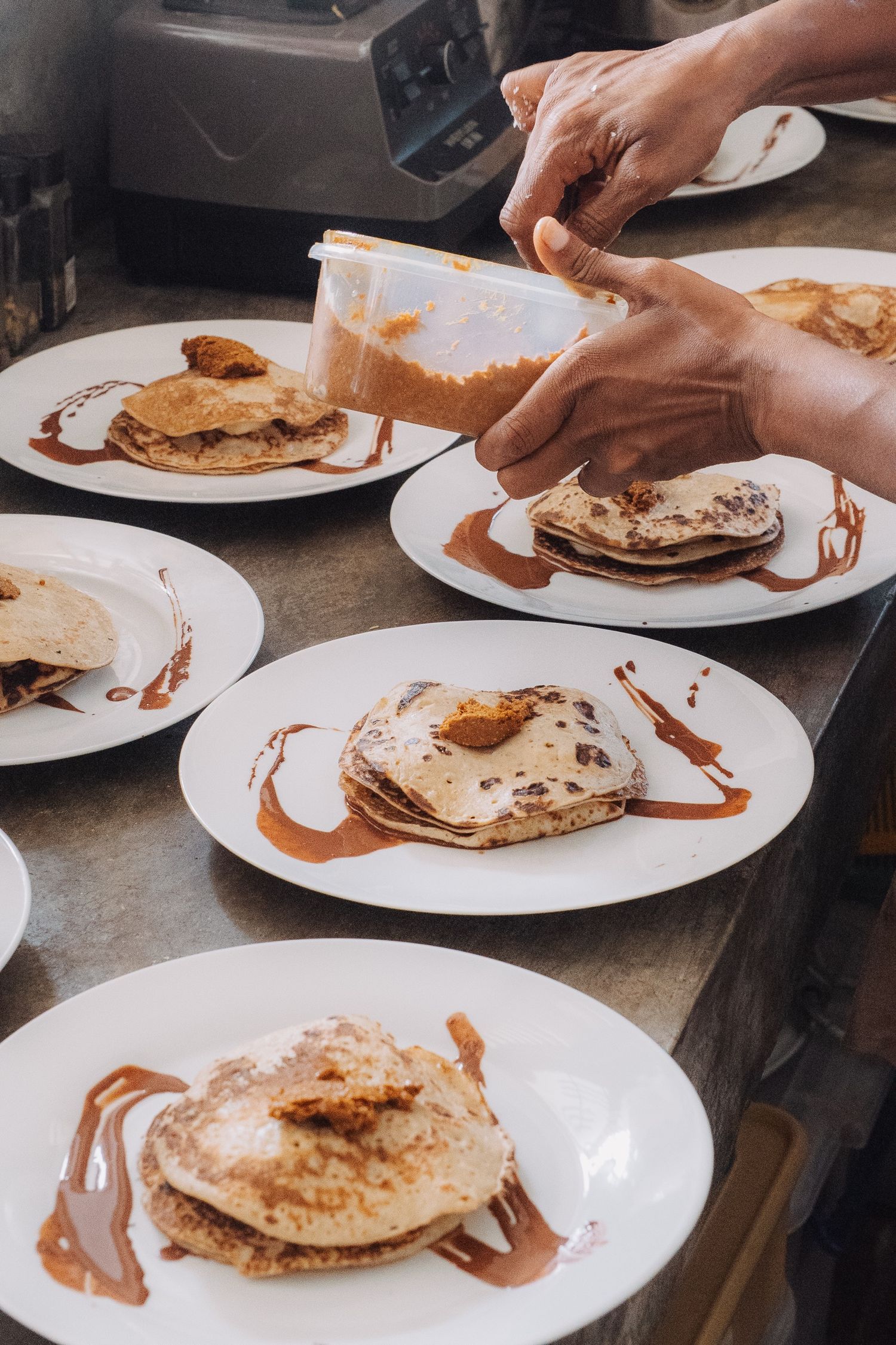 Pancakes being plated in the kitchen