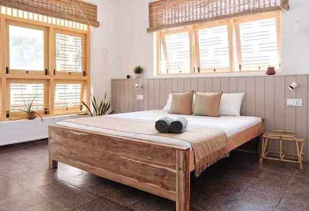 King room with teak bed and yellow shutters