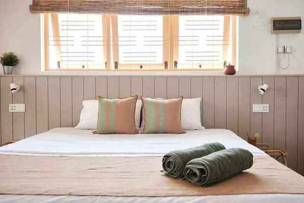 King bed with striped cushions