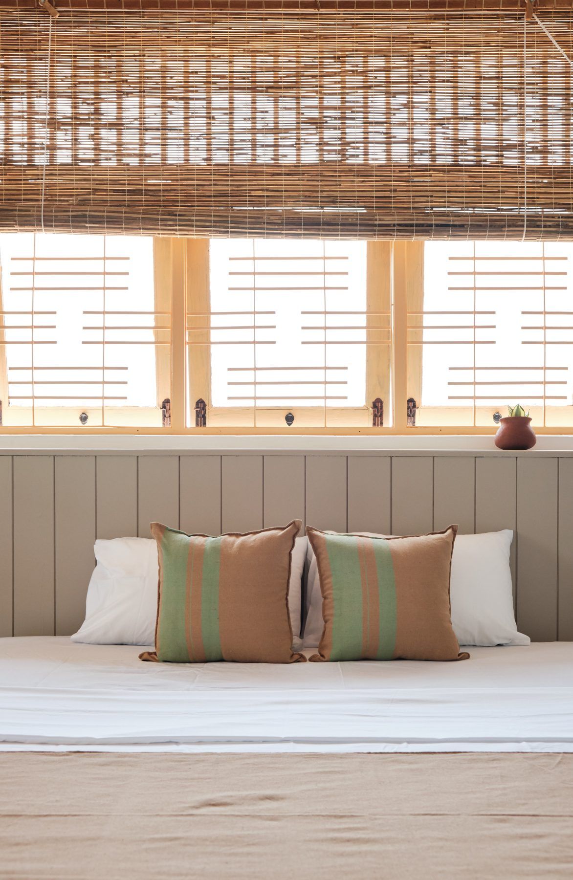 Queen bed with striped cushions