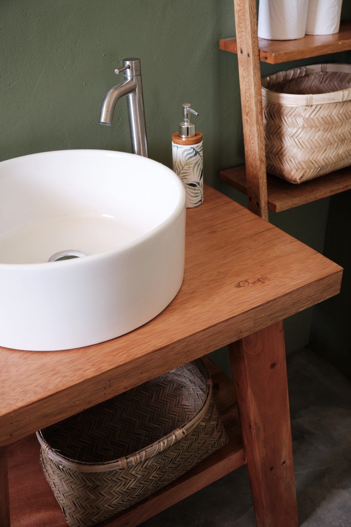 Vanity detail with woven basket storage